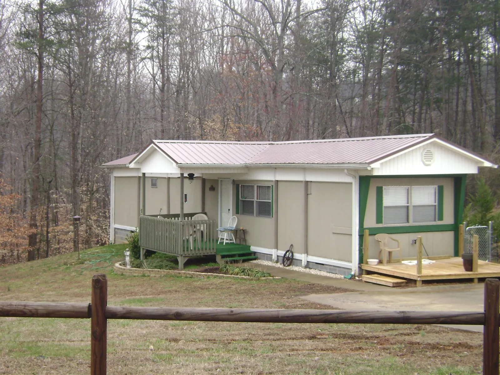 Mauve metal roof on a manufactured home with a new front deck in Grand Mound